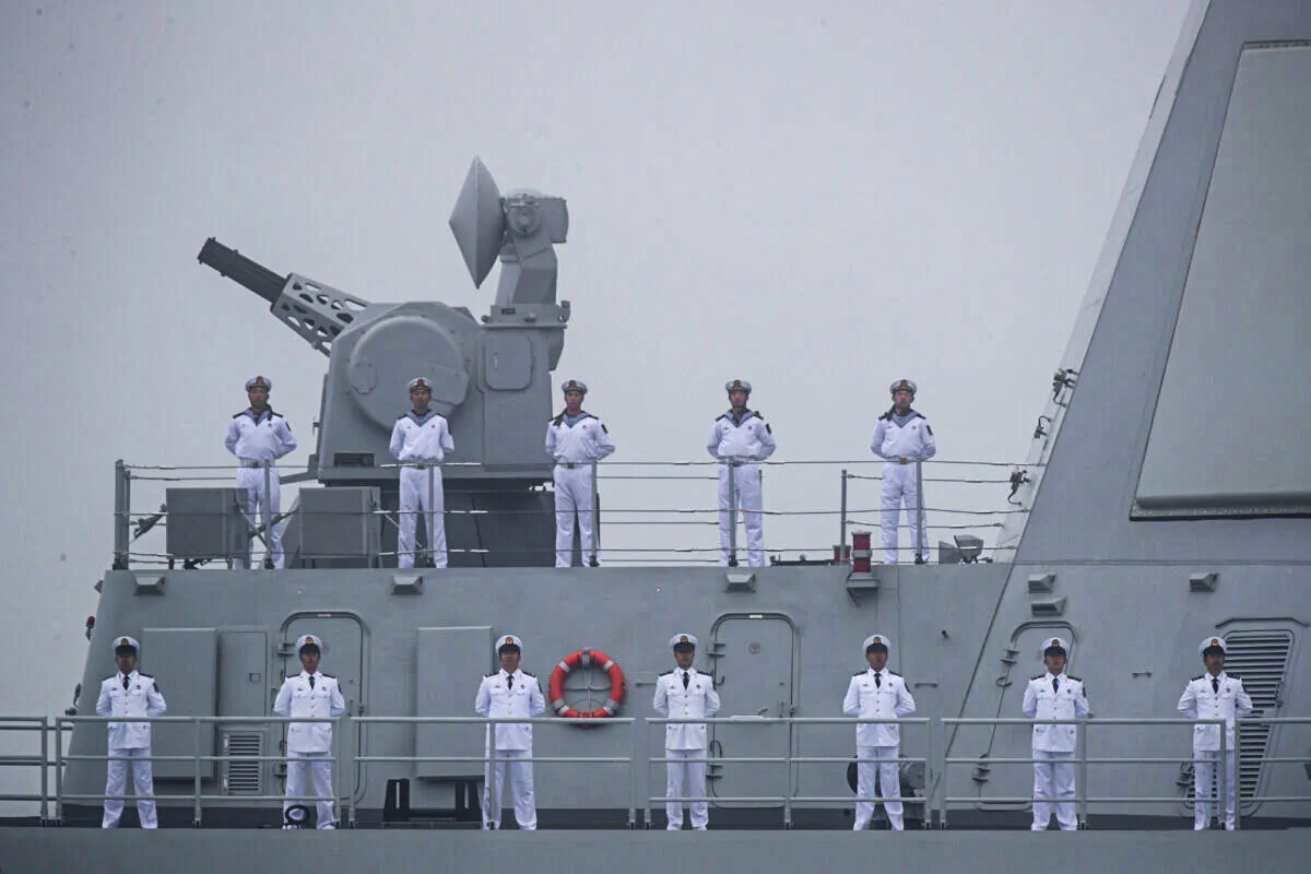 Sailors stand on the deck of the new type 055 guide missile destroyer Nanchang of the Chinese People's Liberation Army Navy (PLAN) as it participates in a naval parade to commemorate the 70th anniversary of the founding of China's PLAN in the sea near Qingdao, in eastern China's Shandong Province on April 23, 2019. (Mark Schiefelbein/AFP via Getty Images)