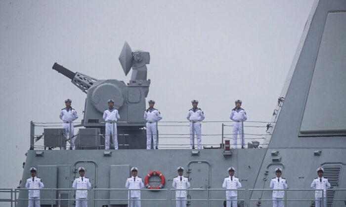 Sailors stand on the deck of the new type 055 guide missile destroyer Nanchang of the Chinese People's Liberation Army Navy (PLAN) as it participates in a naval parade to commemorate the 70th anniversary of the founding of China's PLAN in the sea near Qingdao, in eastern China's Shandong Province on April 23, 2019. (Mark Schiefelbein/AFP via Getty Images)