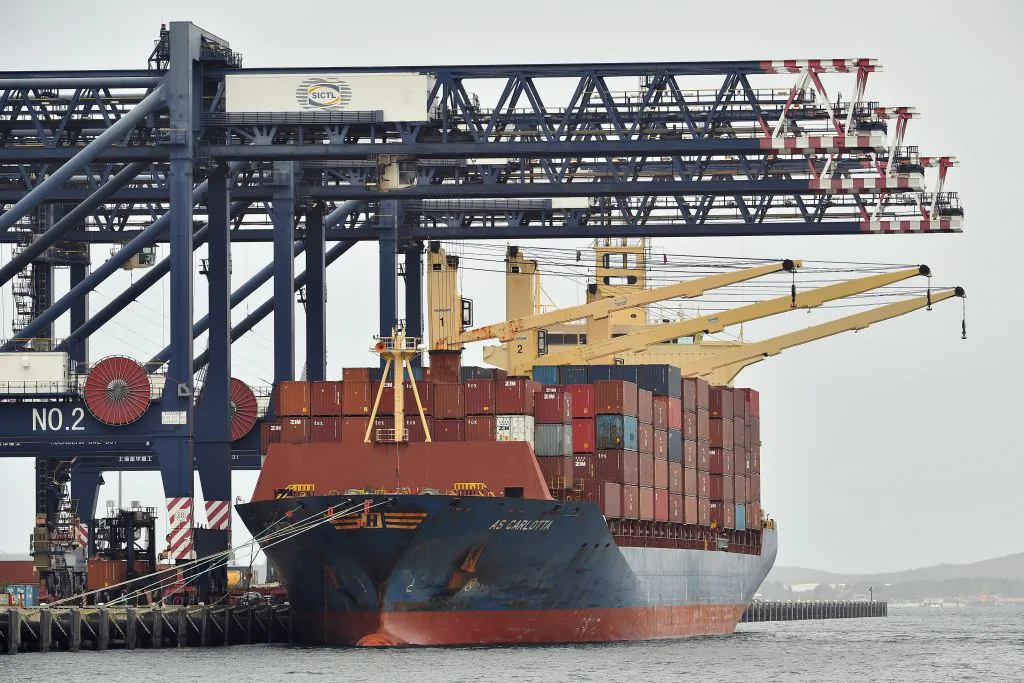 Workers load containers on a cargo ship at Port Botany in Sydney, Australia, on Dec. 2, 2020. (Saeed Khan/AFP via Getty Images)
