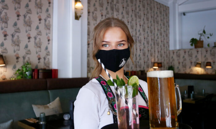 Staff member serves drinks during lunch trade at a bar in Moss Vale, Australia, on Oct. 30, 2021. (Lisa Maree Williams/Getty Images)