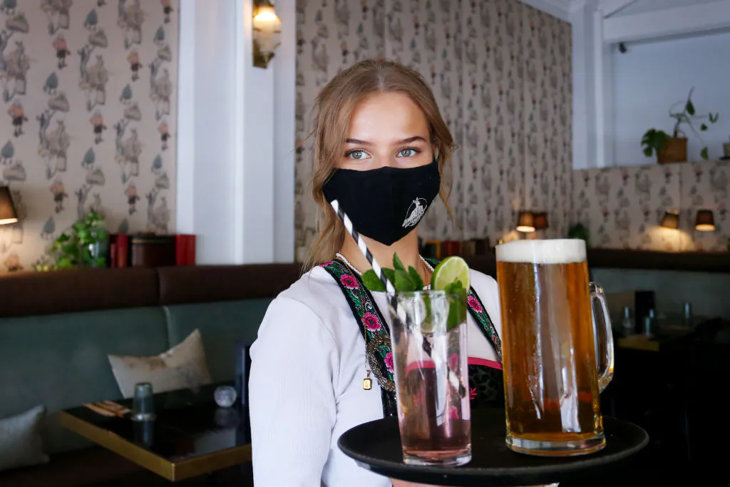 Staff member serves drinks during lunch trade at a bar in Moss Vale, Australia, on Oct. 30, 2021. (Lisa Maree Williams/Getty Images)