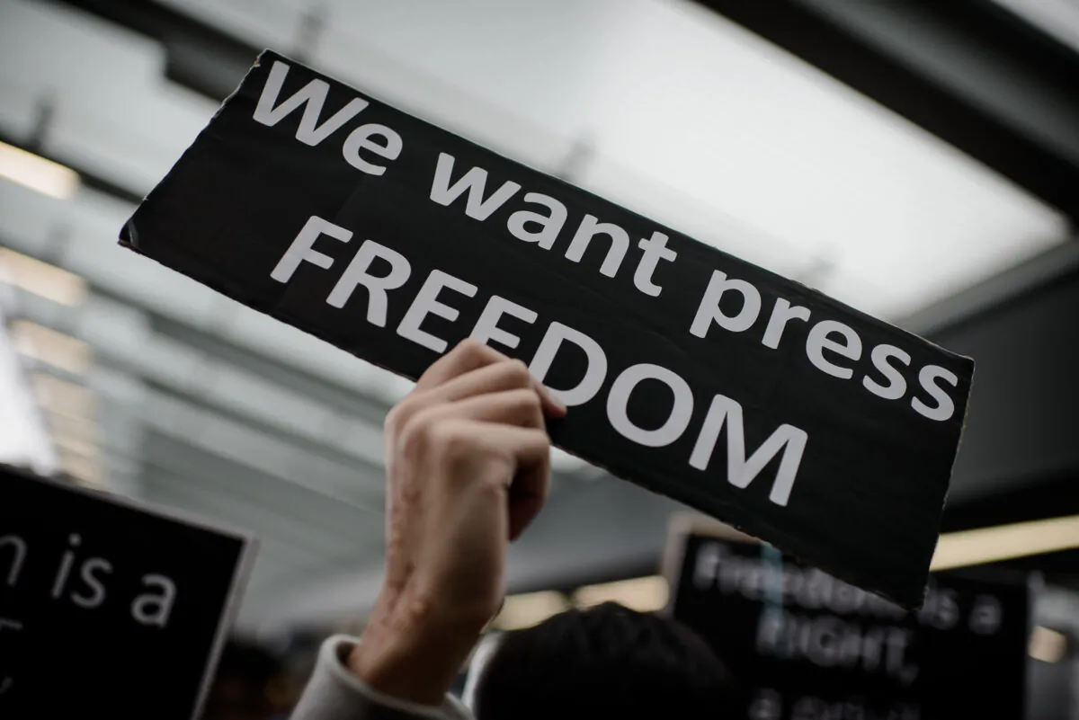 A protester displays a placard during a rally  to support press freedom in Hong Kong on March 2, 2014. (PHILIPPE LOPEZ/AFP via Getty Images)