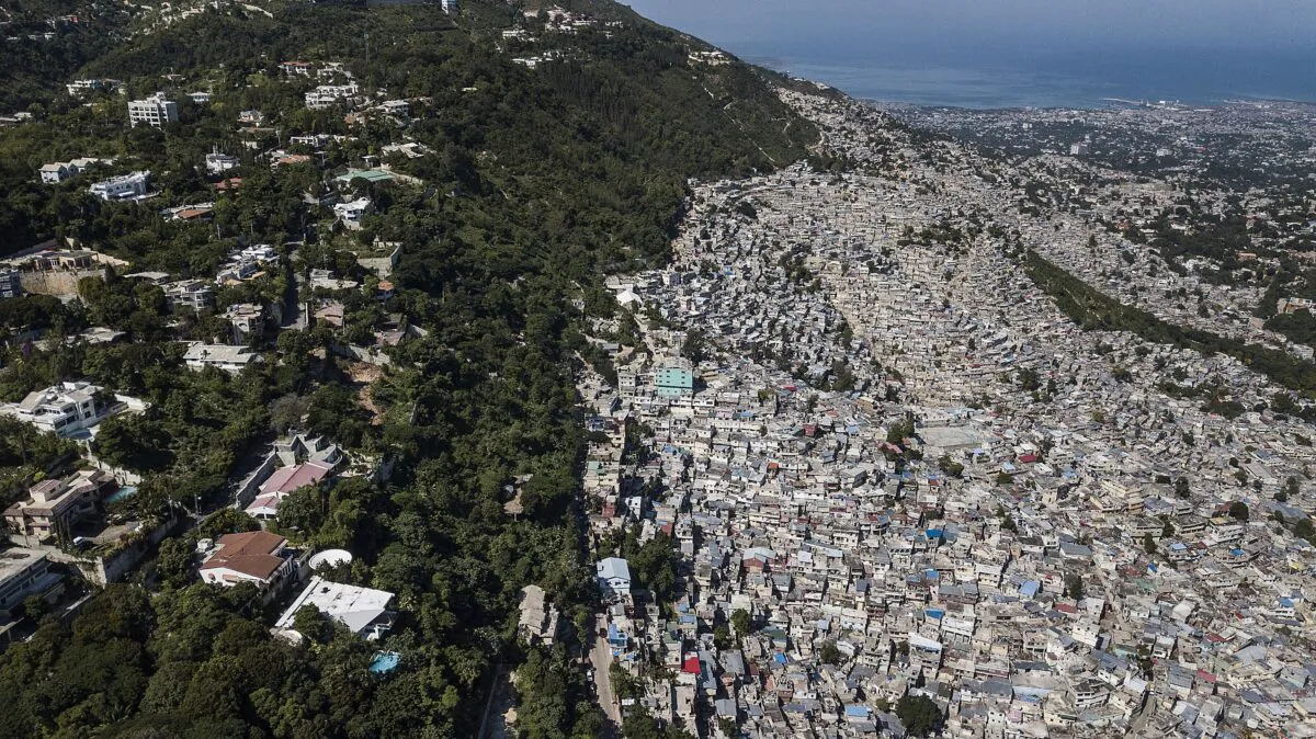 Trees separate an affluent neighborhood, Morne Calvaire, from densely populated homes in the Jalouise neighborhood of Port-au-Prince, Haiti, on Nov. 5, 2021. (Matias Delacroix/AP Photo)