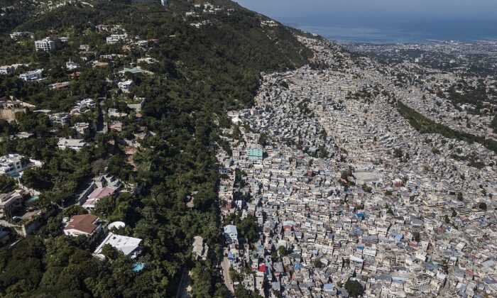 Trees separate an affluent neighborhood, Morne Calvaire, from densely populated homes in the Jalouise neighborhood of Port-au-Prince, Haiti, on Nov. 5, 2021. (Matias Delacroix/AP Photo)
