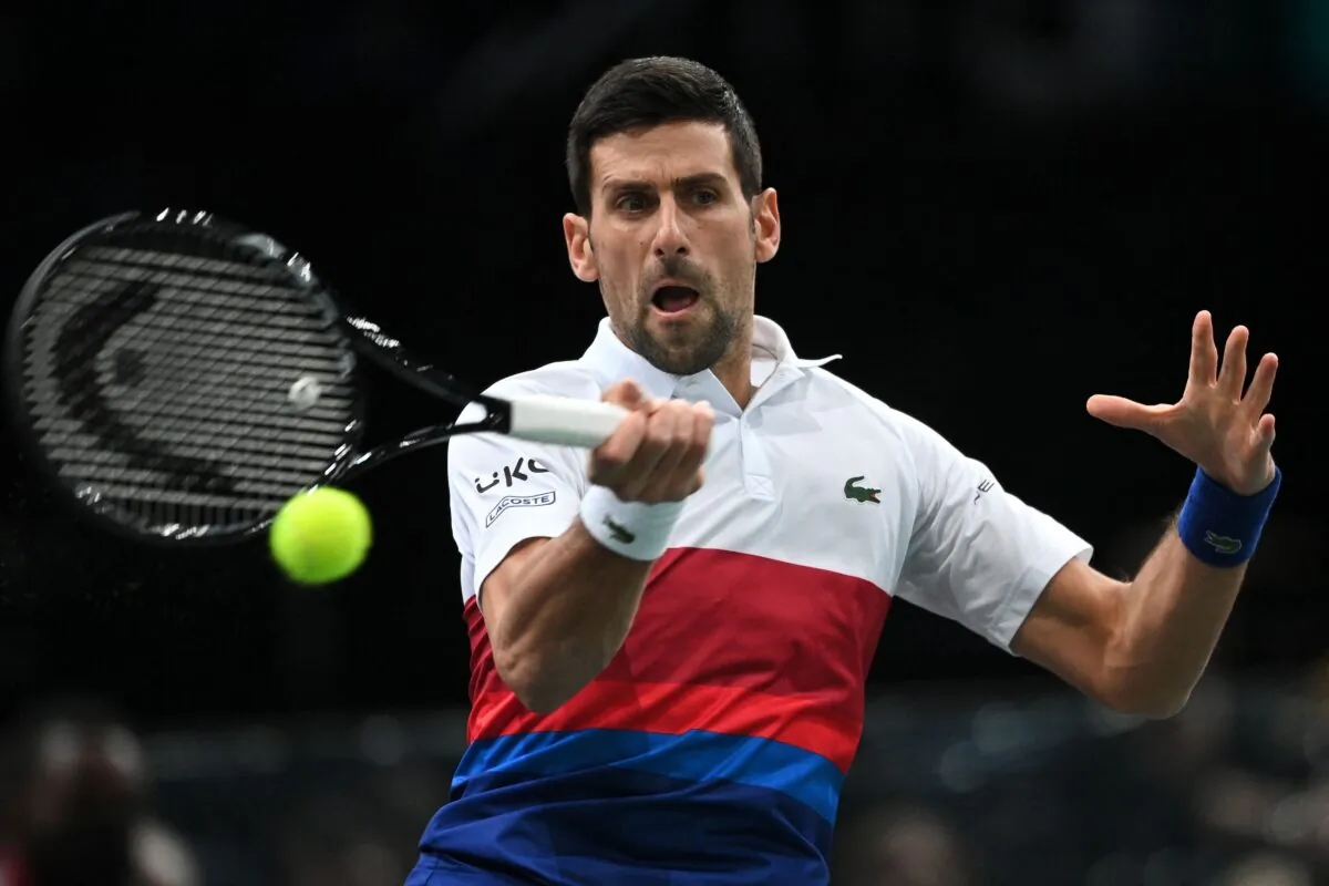 Novak Djokovic of Serbia returns the ball to Taylor Fritz of the United States during their men's singles quarterfinal tennis match on day five of the ATP Paris Masters at The AccorHotels Arena in Paris, France, on Nov. 5, 2021. (Anne-Christine Poujoulat/AFP via Getty Images)