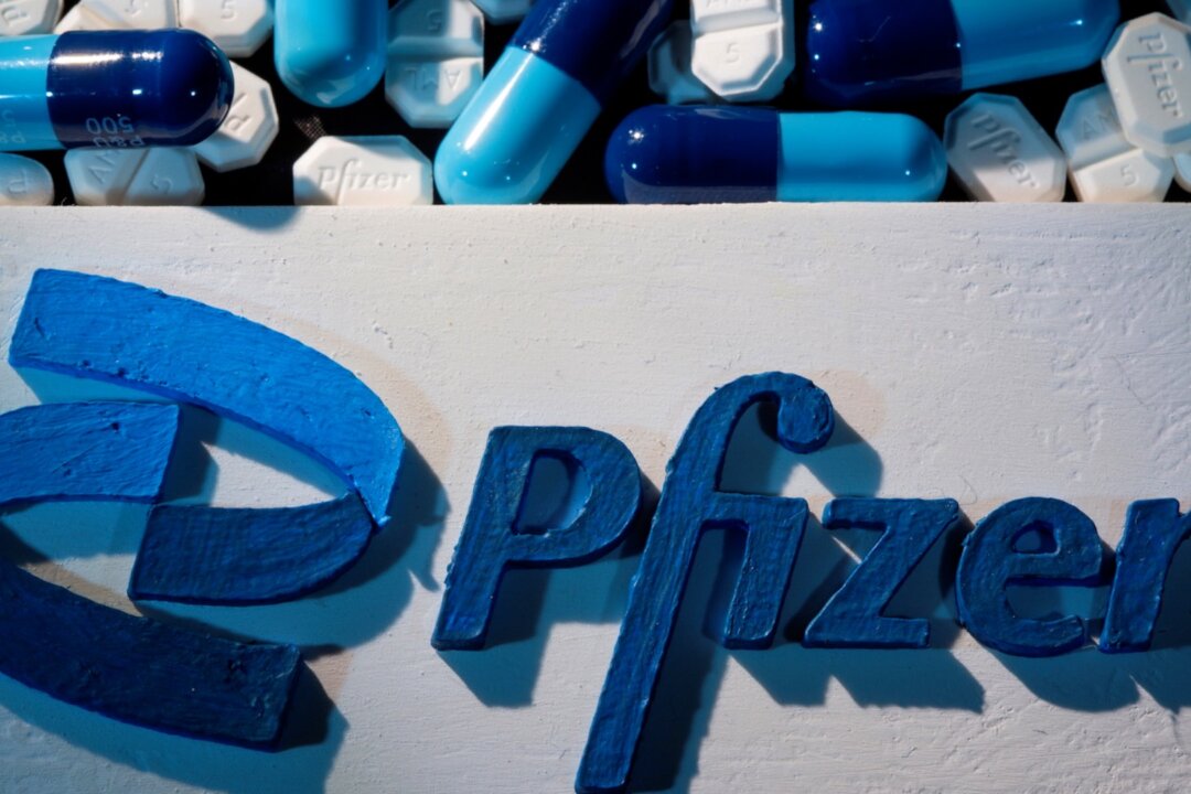 A 3D printed Pfizer logo is placed near medicines from the same manufacturer in this illustration taken on Sept. 29, 2021. (Dado Ruvic/Reuters)