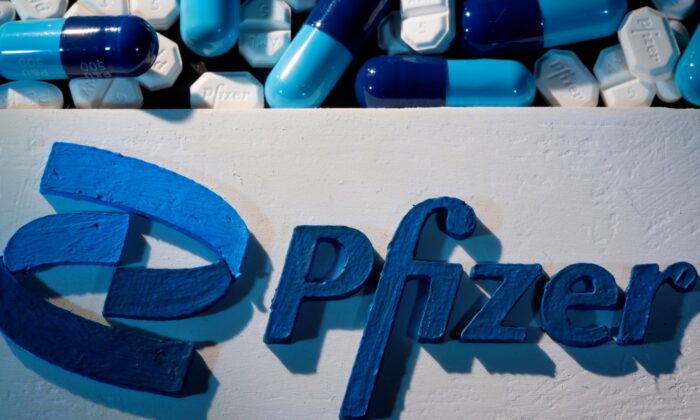 A 3D printed Pfizer logo is placed near medicines from the same manufacturer in this illustration taken on Sept. 29, 2021. (Dado Ruvic/Reuters)