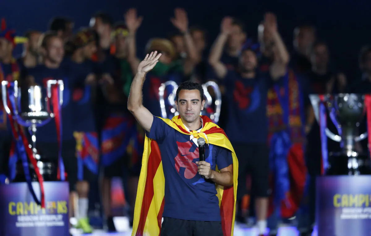 Barcelona's Xavi Hernandez waves to the fans during celebrations at the Camp Nou stadium after winning the Champions League soccer final in Barcelona, Spain, on June 7, 2015. (Manu Fernandez/AP Photo)