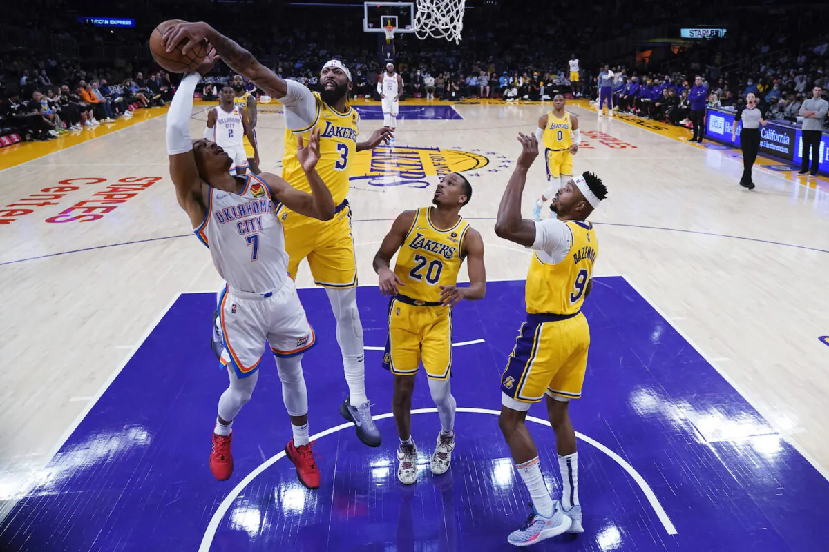 Los Angeles Lakers forward Anthony Davis (3) blocks a shot from Oklahoma City Thunder forward Darius Bazley (7) during the first half of an NBA basketball game in Los Angeles on Nov. 4, 2021. (AP Photo/Marcio Jose Sanchez)