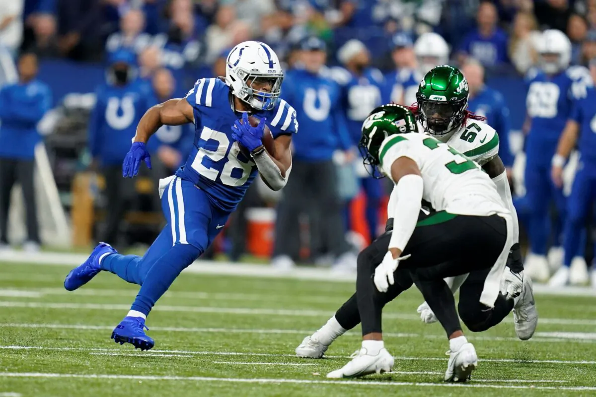 Indianapolis Colts' Jonathan Taylor (28) runs against New York Jets' Bryce Hall (37) during the first half of an NFL football game in Indianapolis, Ind., on Nov. 4, 2021. (Michael Conroy/AP Photo)