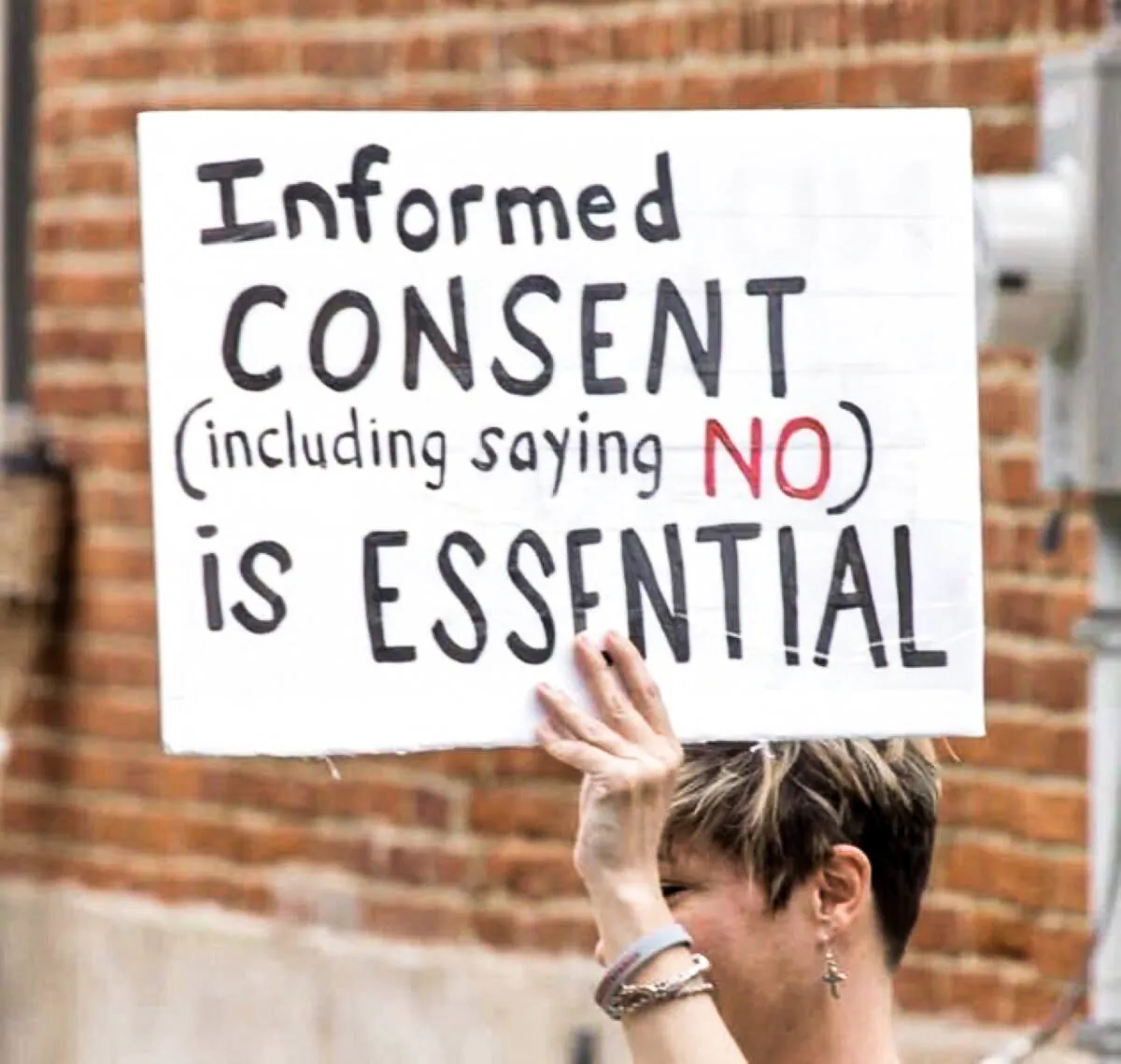 A protester holds a sign during a rally in support of health workers in Pennsylvania. (Courtesy of   Pennsylvania Informed Consent Advocates Inc.)