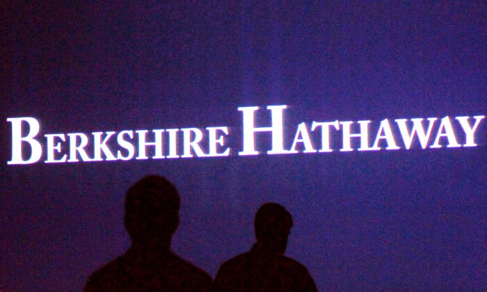 Berkshire Hathaway shareholders walk by a video screen at the company's annual meeting in Omaha on May 4, 2013. (Rick Wilking/Reuters)