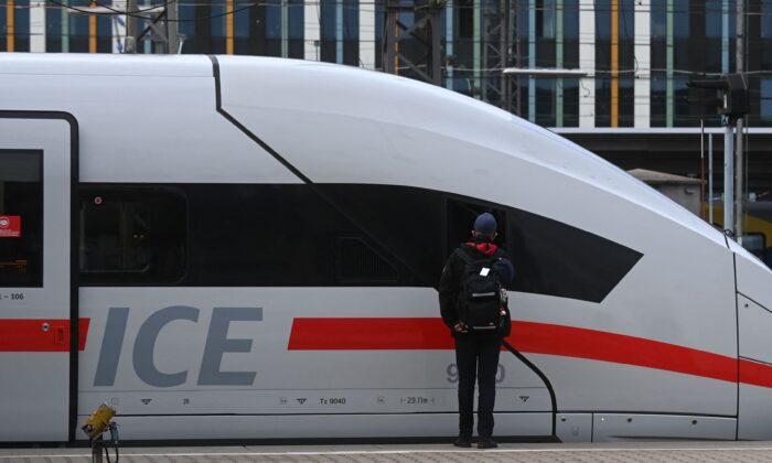 On August 23, 2021, an employee of Deutsche Bahn (DB), a German railway operator, stands next to the ICE high-speed train at a major railway station in Munich, southern Germany.  (Christof Stache / AFP via Getty Images)