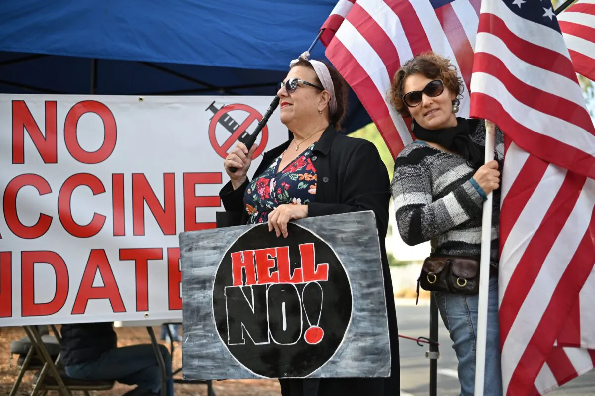 Workers at NASA's Jet Propulsion Laboratory (JPL) and their supporters protest outside JPL against a U.S. government mandate requiring all federal employees to receive the COVID-19 vaccine, in Pasadena, Calif., on Nov 1, 2021. (Robyn Beck/Getty Images)