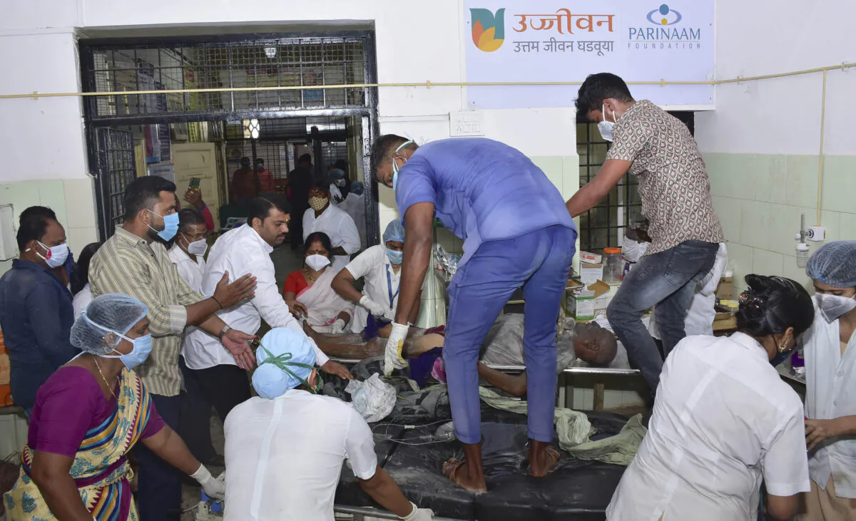 A man is carried for treatment after a fire in a hospital's COVID-19 ward that caught fire in Ahmednagar, in the western Indian state of Maharashtra on Nov. 6, 2021. (AP Photo)