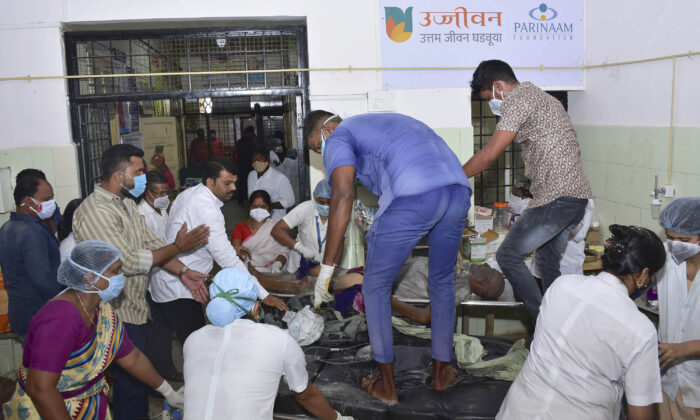 A antheral   is carried for attraction    aft  a occurrence  successful  a hospital's COVID-19 ward that caught occurrence  successful  Ahmednagar, successful  the occidental  Indian authorities   of Maharashtra connected  Nov. 6, 2021. (AP Photo)
