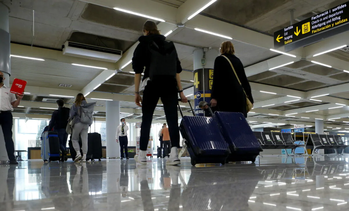 Passengers wearing protective face masks arrive at Son Sant Joan airport in Palma de Mallorca, Spain, on April 1, 2021. (Enrique Calvo/File Photo/Reuters)