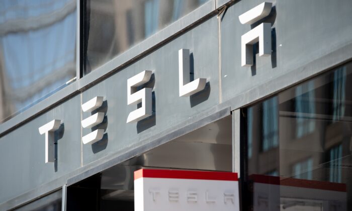 The Tesla logo is seen outside of their showroom in Washington, on Aug. 8, 2018. (Saul Loeb/AFP via Getty Images)