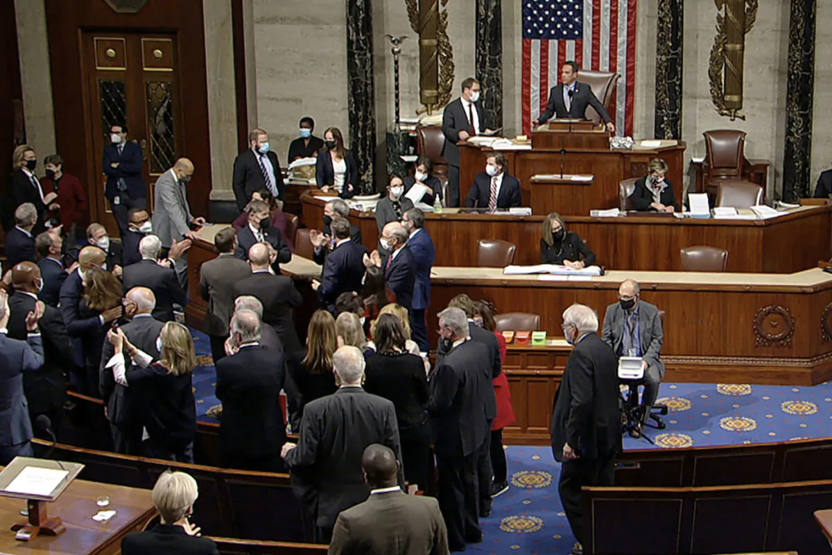 Democrats celebrate on the House floor in Washington, on Nov. 5, 2021. (House Television via AP)