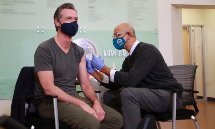 California Gov. Gavin Newsom receives a Moderna COVID-19 vaccine booster dose at the Oakland Health Clinic on Oct. 27. (California Governor's Office)