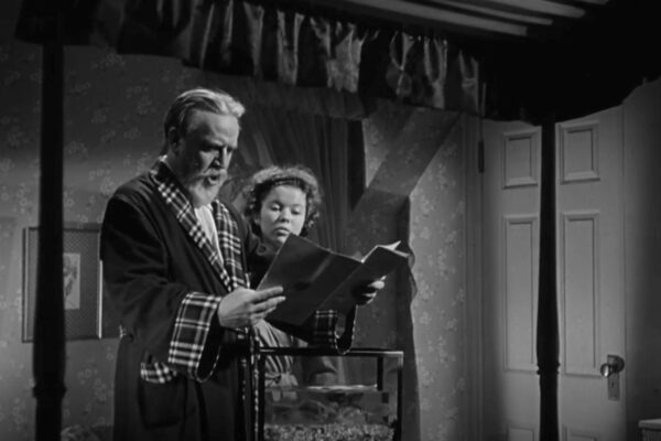 old man and girl looking at a book