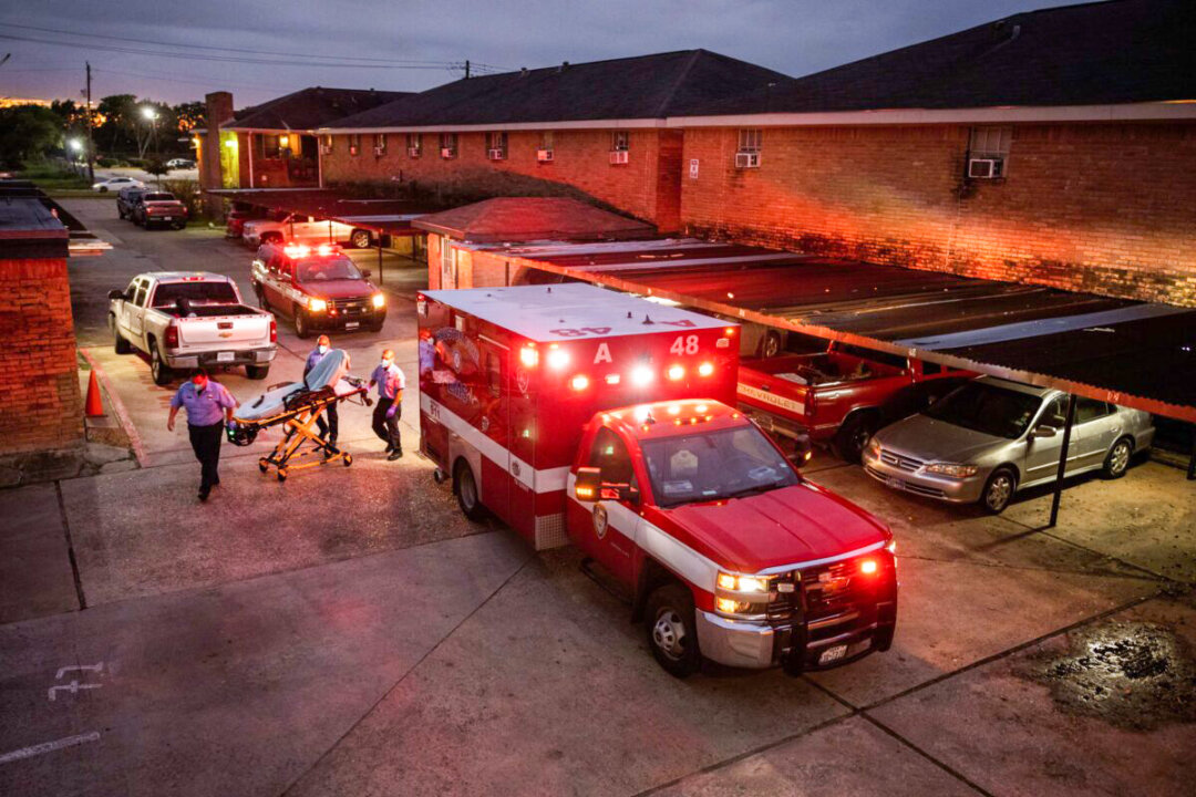 Houston Fire Department paramedics prepare to transport a COVID-19 positive woman to a hospital  in Houston, Texas, on Sept. 15, 2021. (John Moore/Getty Images)
