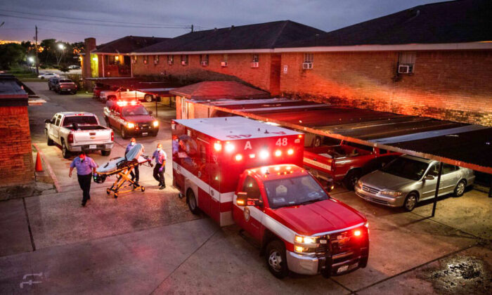Houston Fire Department paramedics prepare to transport a COVID-19 positive woman to a hospital  in Houston, Texas, on Sept. 15, 2021. (John Moore/Getty Images)
