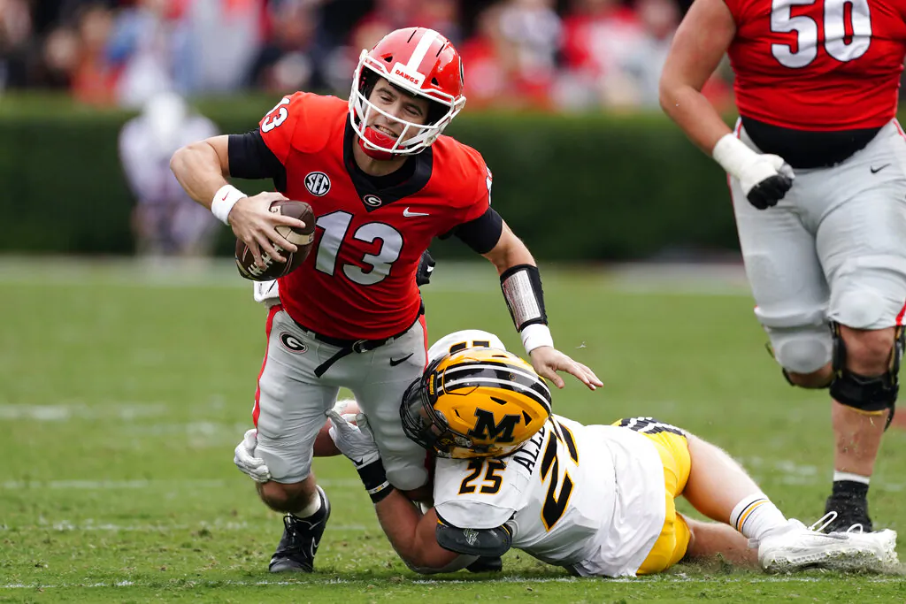 Georgia quarterback Stetson Bennett (13) is stopped by Missouri linebacker Blaze Alldredge (25) in the first half of an NCAA college football game in Athens, Ga., on Nov. 6, 2021. (John Bazemore/AP Photo)
