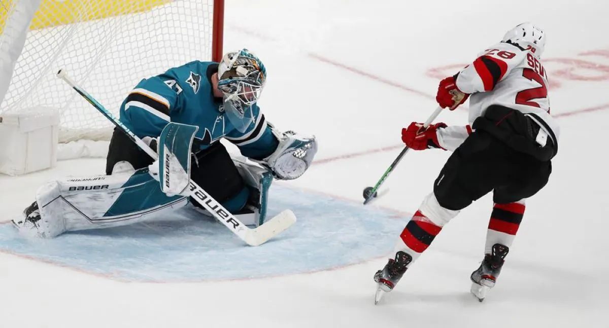 San Jose Sharks goaltender James Reimer (47) watches the puck as New Jersey Devils defenseman
Damon Severson (28) shoots for a goal in the shootout of an NHL hockey game in San Jose, Calif., on Nov. 6, 2021.(Josie Lepe/AP Photo)