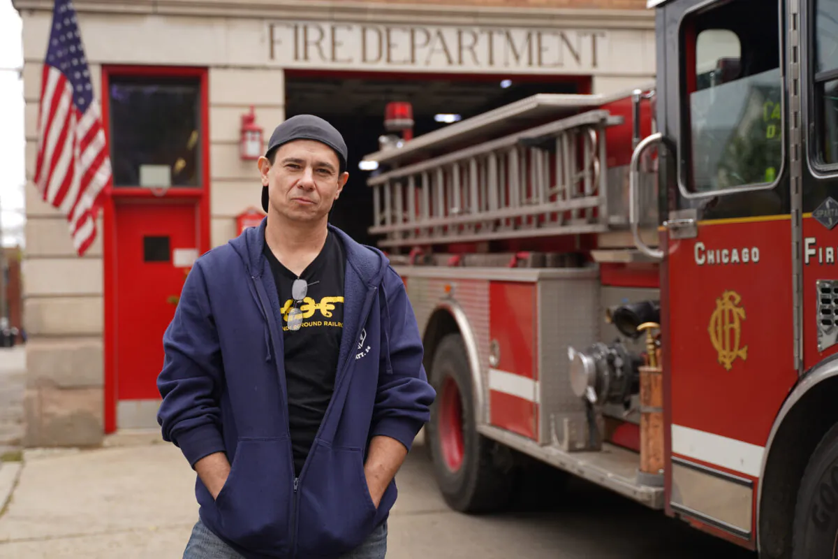 Scott Troogstad stands in front of Engine Company 99 of Chicago Fire Department, on the southwest side of Chicago on Oct. 28, 2021. (Cara Ding/The Epoch Times)