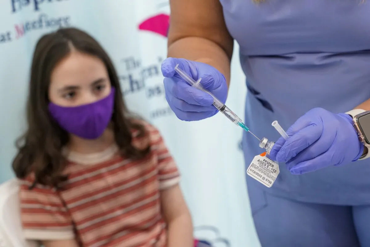 An 11-year-old girl watches as a nurse prepares a syringe with a dose of Pfizer's COVID-19 vaccine, at The Children's Hospital at Montefiore in New York on Nov. 3, 2021. (Mary Altaffer/AP Photo)