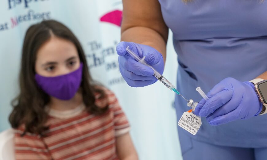 An 11-year-old girl watches as a nurse prepares a syringe with a dose of Pfizer's COVID-19 vaccine, at The Children's Hospital at Montefiore in New York City on Nov. 3, 2021. (Mary Altaffer/AP Photo)