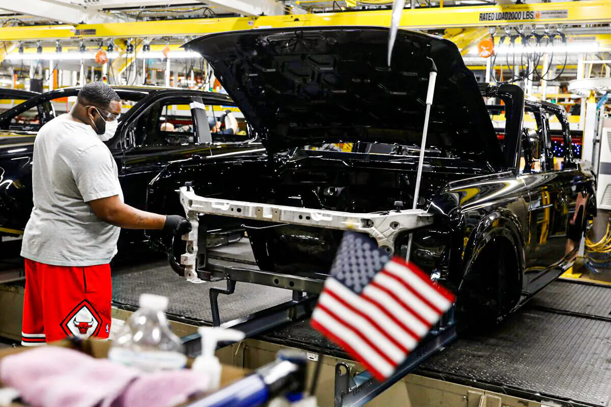 A line worker assembles Ford Motor Company's 2021 Ford Bronco on the line at the Michigan Assembly Plant in Wayne, Mich., on June 14, 2021. (JEFF KOWALSKY/AFP via Getty Images)