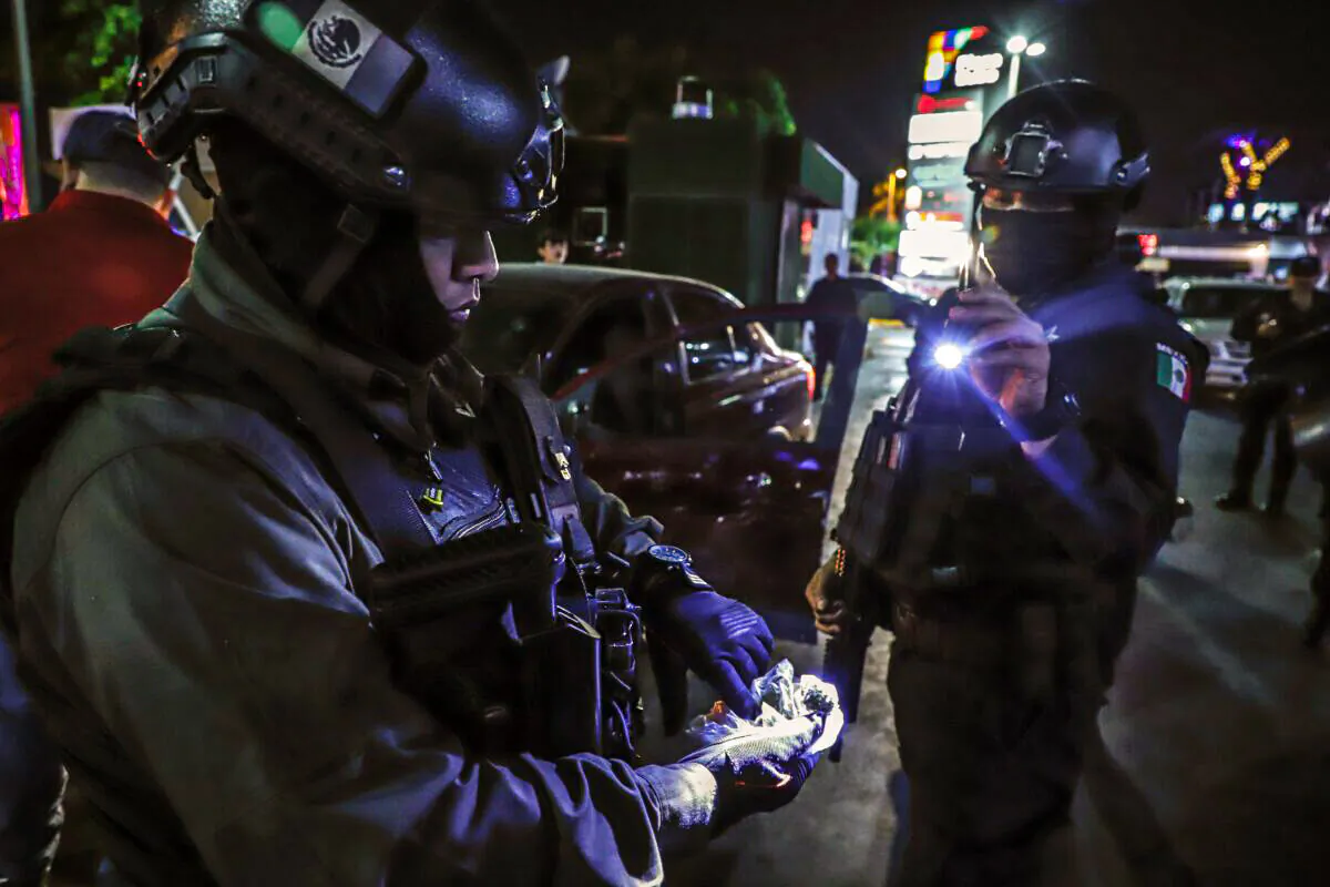 Sinaloa state police agents check a plastic bag with a suspicious substance found during a security operation in the city of Culiacan, , which used to be one of "El Chapo" Guzman's major influence areas, in Sinaloa state, Mexico, on Feb. 15, 2019. (Rashide Frias/AFP via Getty Images)