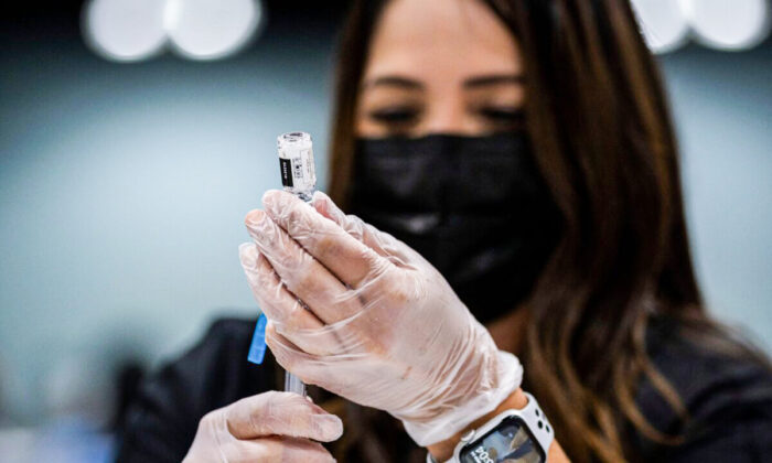 A health worker prepares a dose of the Johnson&Johnson COVID-19 vaccine at the Puerto Rico Convention Center during the first mass vaccination event in San Juan, Puerto Rico, on March 31, 2021. (Ricardo Arduengo/AFP via Getty Images)