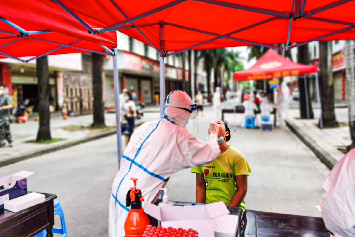 A resident undergoes nucleic acid testing for the COVID-19 coronavirus in the city of Ruili which borders Myanmar, in China's southwestern Yunnan province on July 5, 2021. (STR/AFP via Getty Images)