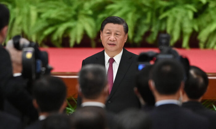 Chinese leader Xi Jinping sings the national anthem during a reception at the Great Hall of the People on the eve of China's National Day in Beijing on Sept. 30, 2021. (Greg Baker/AFP via Getty Images)