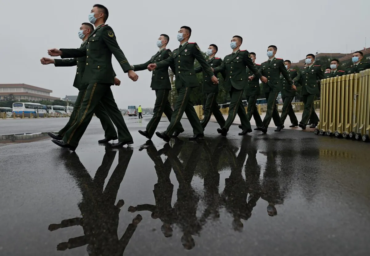 Military delegates march at the Great Hall of the People in Beijing on Oct. 9, 2021. (Noel Celis/AFP via Getty Images)