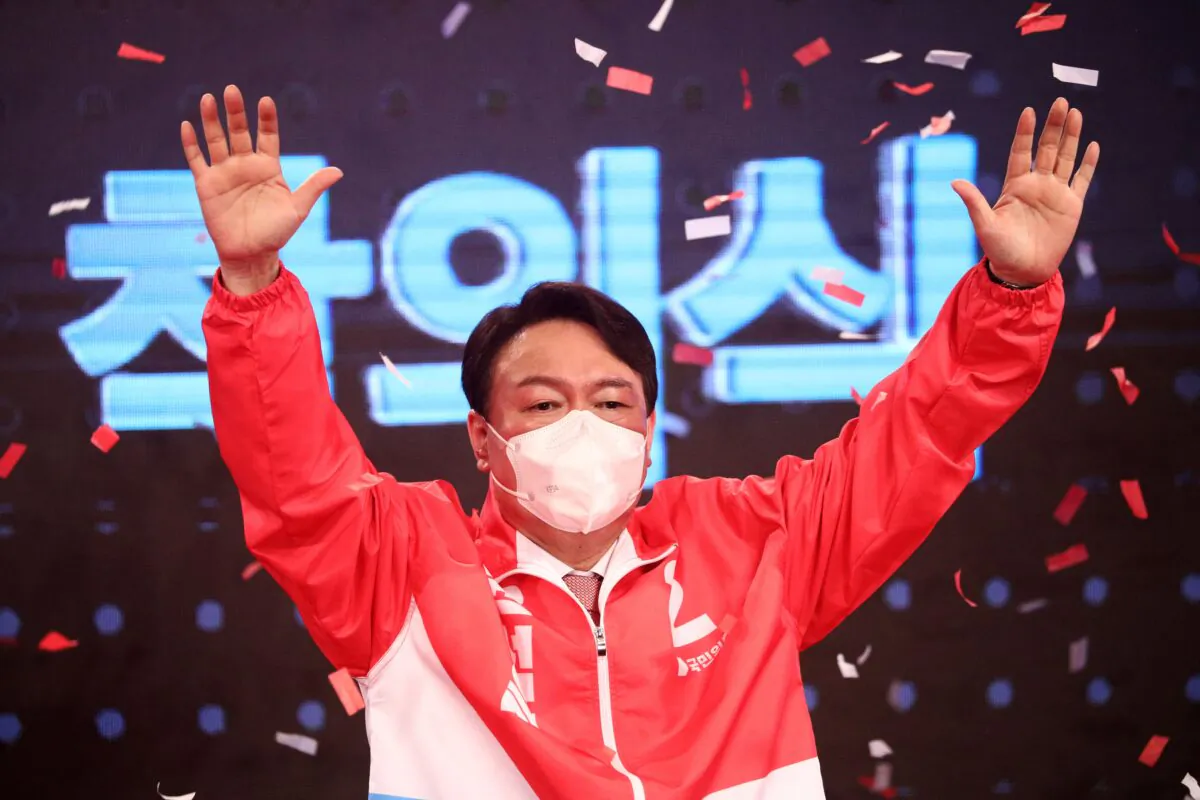 Former prosecutor general Yoon Seok-youl from South Korea's main opposition People Power Party waves after being chosen as the party's candidate in next year's presidential election in Seoul, on Nov. 5, 2021. (Kim Hong-Ji/POOL/AFP via Getty Images)