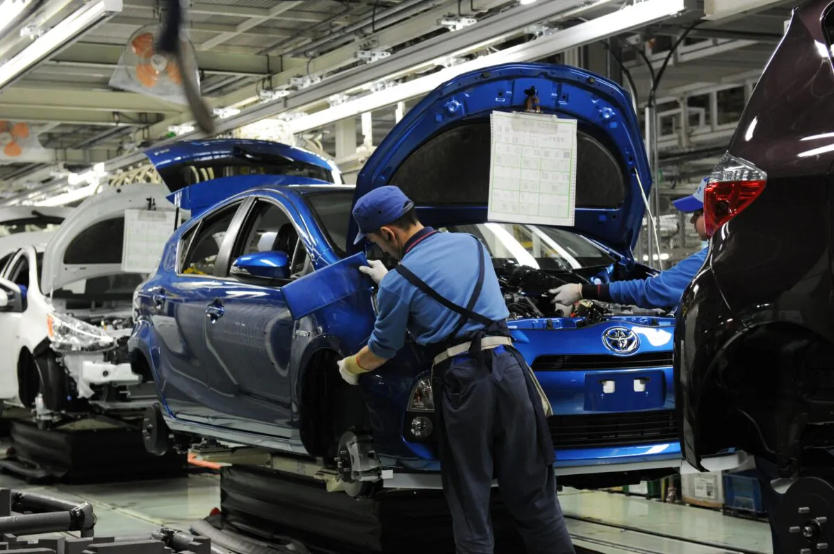 Workers assemble the front bumper of Toyota's compact hybrid vehicle "AQUA" on the assembly line of the Kanto Auto Works' Iwate plant in the Kanegasaki town, Iwate Prefecture, about 310. miles north of Tokyo, on March 9, 2012.   (Toshifumi KitamuraI/AFP via Getty Images)