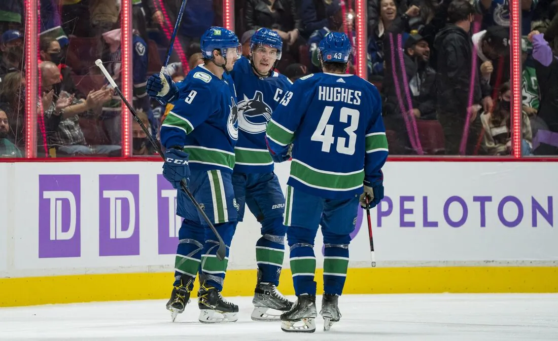 Vancouver Canucks forward J.T. Miller (9) and forward Bo Horvat (53) and defenseman Quinn Hughes (43) celebrate Miller’s goal against the Dallas Stars in the second period at Rogers Arena, in Vancouver, British Columbia, Canada, on Nov. 7, 2021. (Bob Frid/USA TODAY Sports via Field Level Media)