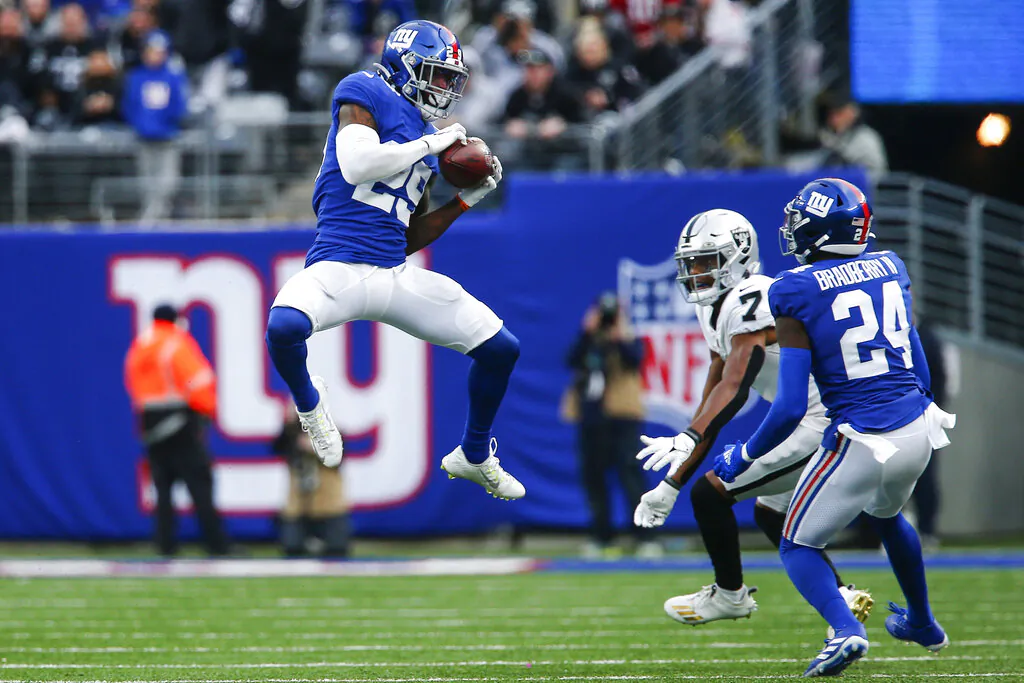 New York Giants free safety Xavier McKinney (29) intercepts a pass intended for Las Vegas Raiders' Zay Jones (7) as Giants' James Bradberry (24) watches during the second half of an NFL football game in East Rutherford, N.J., on Nov. 7, 2021. (John Munson/AP Photo)