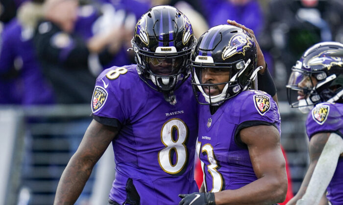 Baltimore Ravens quarterback Lamar Jackson (8) and wide receiver Devin Duvernay (13) celebrate after connecting for a touchdown during the second half of an NFL football game against the Minnesota Vikings in Baltimore, on Nov. 7, 2021.(Nick Wass/AP Photo)