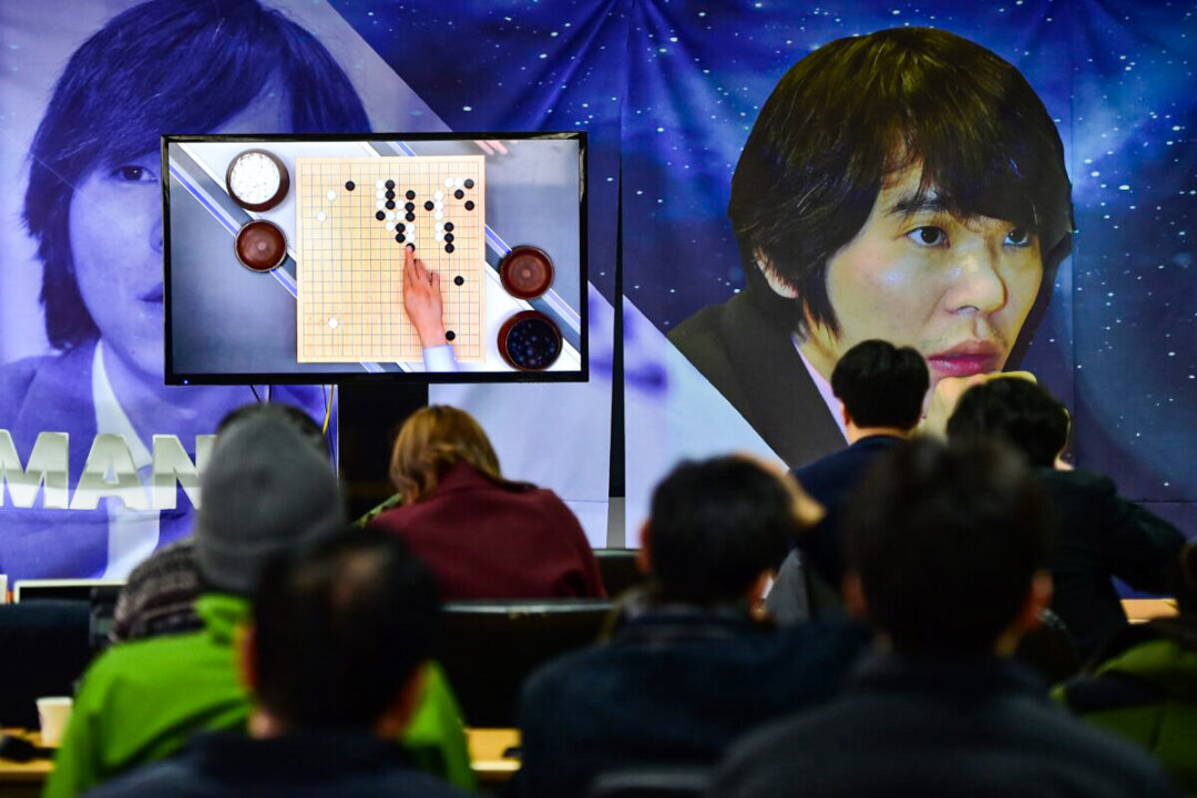 South Korean Go game fans watch a television screen broadcasting live footage of the Google DeepMind Challenge Match, at the Korea Baduk Association in Seoul on March 9, 2016. (JUNG YEON-JE/AFP via Getty Images)