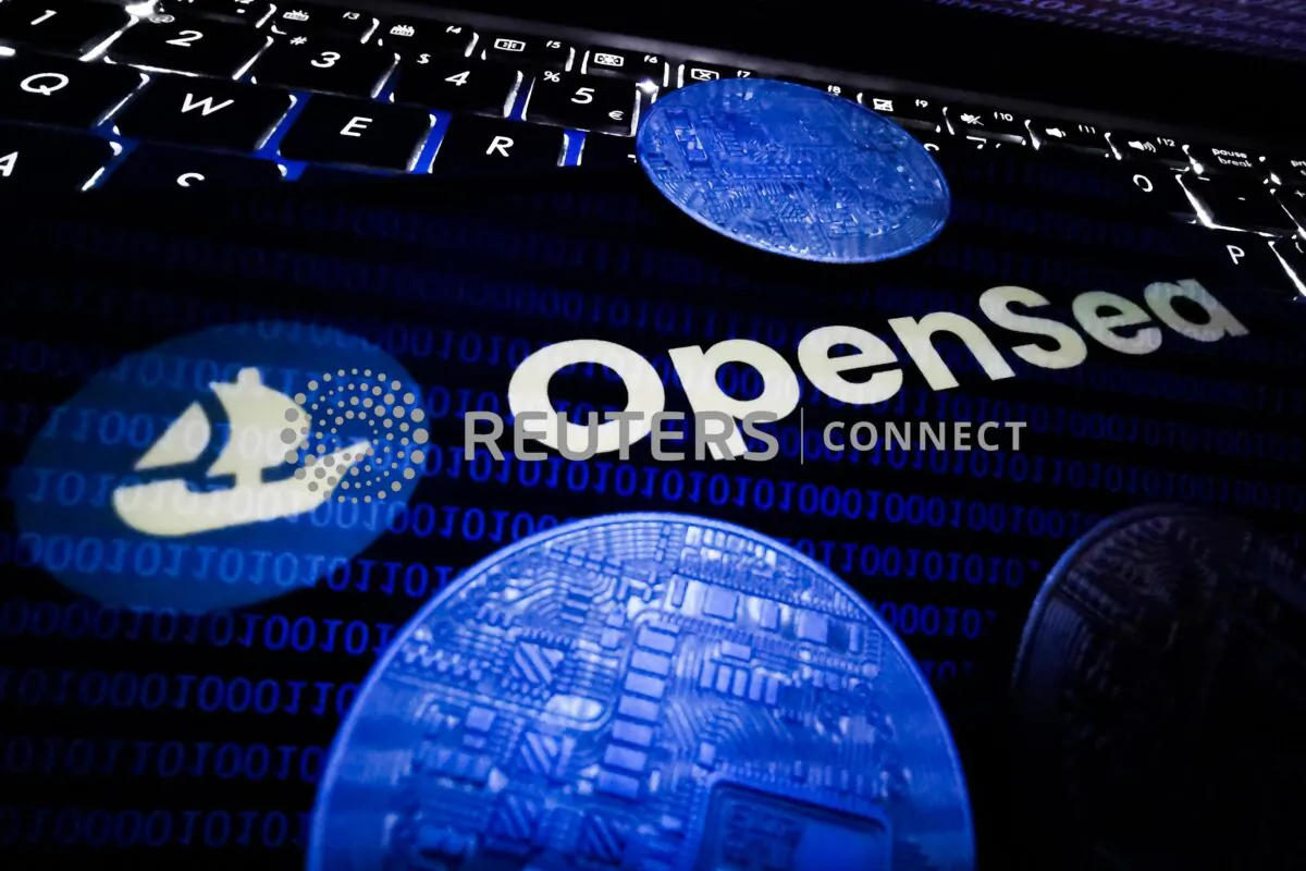 OpenSea logo displayed on a phone screen, representation of cryptocurrencies and NFT logo displayed on a laptop screen are seen in this illustration photo taken in Krakow, Poland on Aug. 26, 2021. (Jakub Porzycki/NurPhoto Via Reuters)