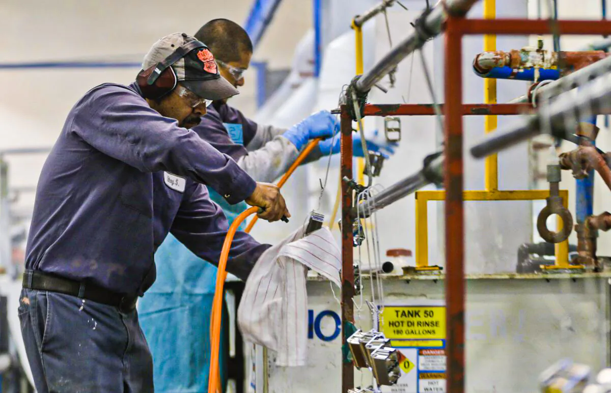 In this file photo, employees at Sheffield Platers Inc. work on the factory floor in San Diego, Calif., on Oct. 10, 2013. (AP Photo/Lenny Ignelzi)