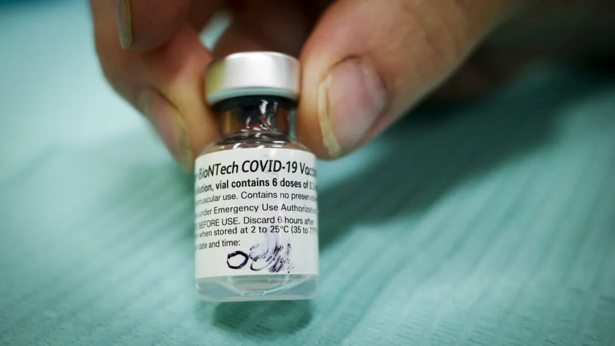 A vial of Pfizer-BioNTech COVID-19 vaccine is pictured at an Alberta Health Services vaccination clinic in Didsbury, Alta., on June 29, 2021. (The Canadian Press/Jeff McIntosh)