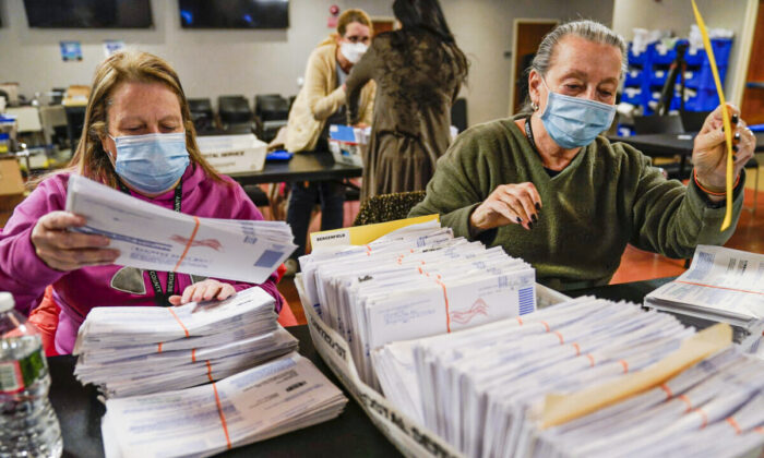 Board workers Bernadette Witt, left, and JoAnn Bartlett, right, process and double-check mail-in ballots for Bergen County in Hackensack, N.J. Wednesday, Nov. 3, 2021. (Seth Wenig/AP Photo)