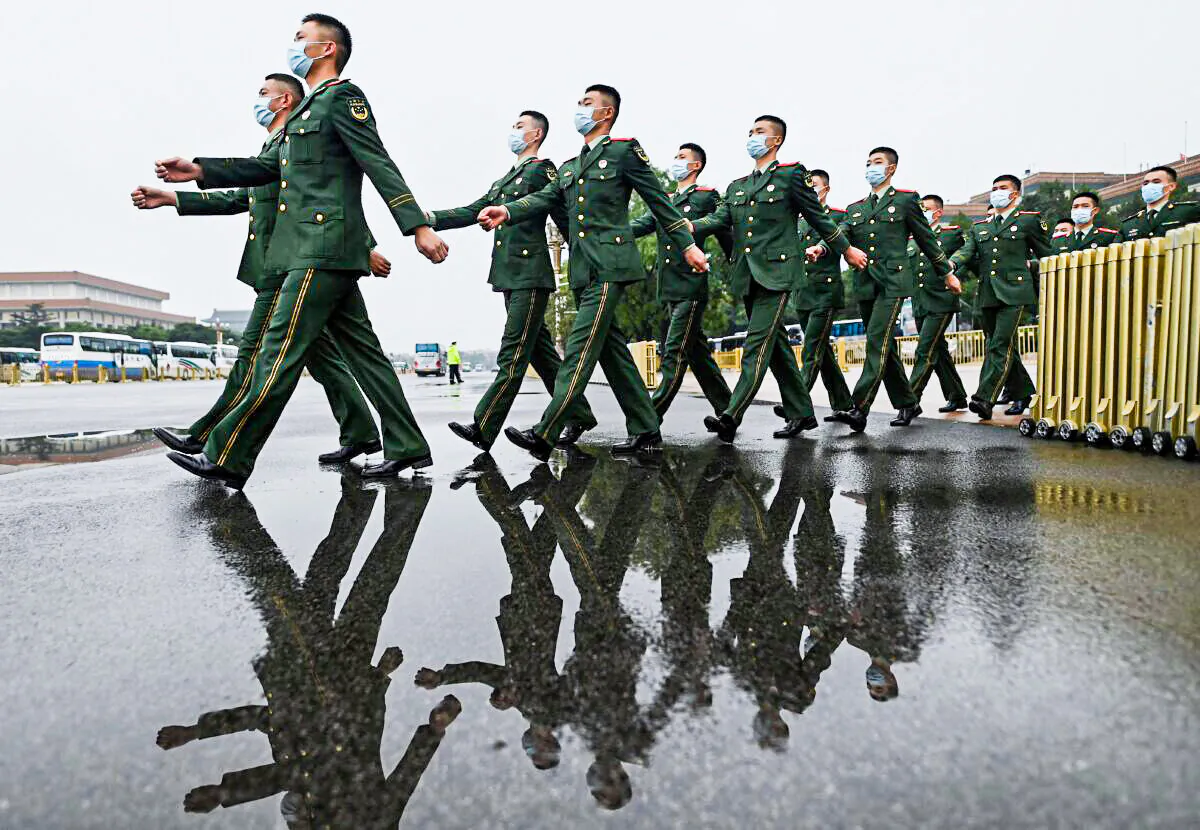 Military delegates march as they leave after the commemoration of the 110th anniversary of the Xinhai Revolution which overthrew the Qing Dynasty and led to the founding of the Republic of China, at the Great Hall of the People in Beijing on October 9, 2021. (Photo by Noel Celis / AFP) (Photo by NOEL CELIS/AFP via Getty Images)