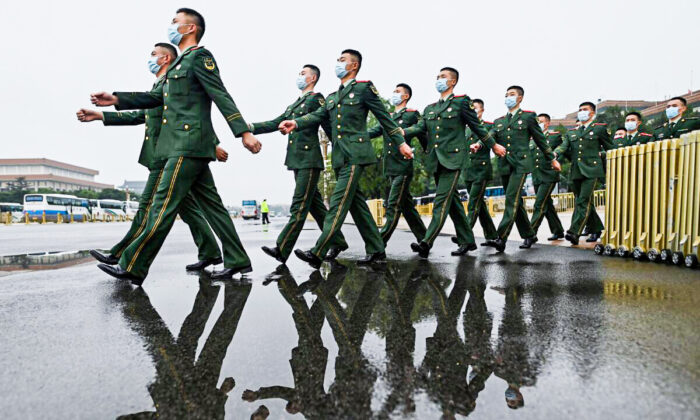 Military delegates march at the Great Hall of the People in Beijing on Oct. 9, 2021. (Noel Celis/AFP via Getty Images)